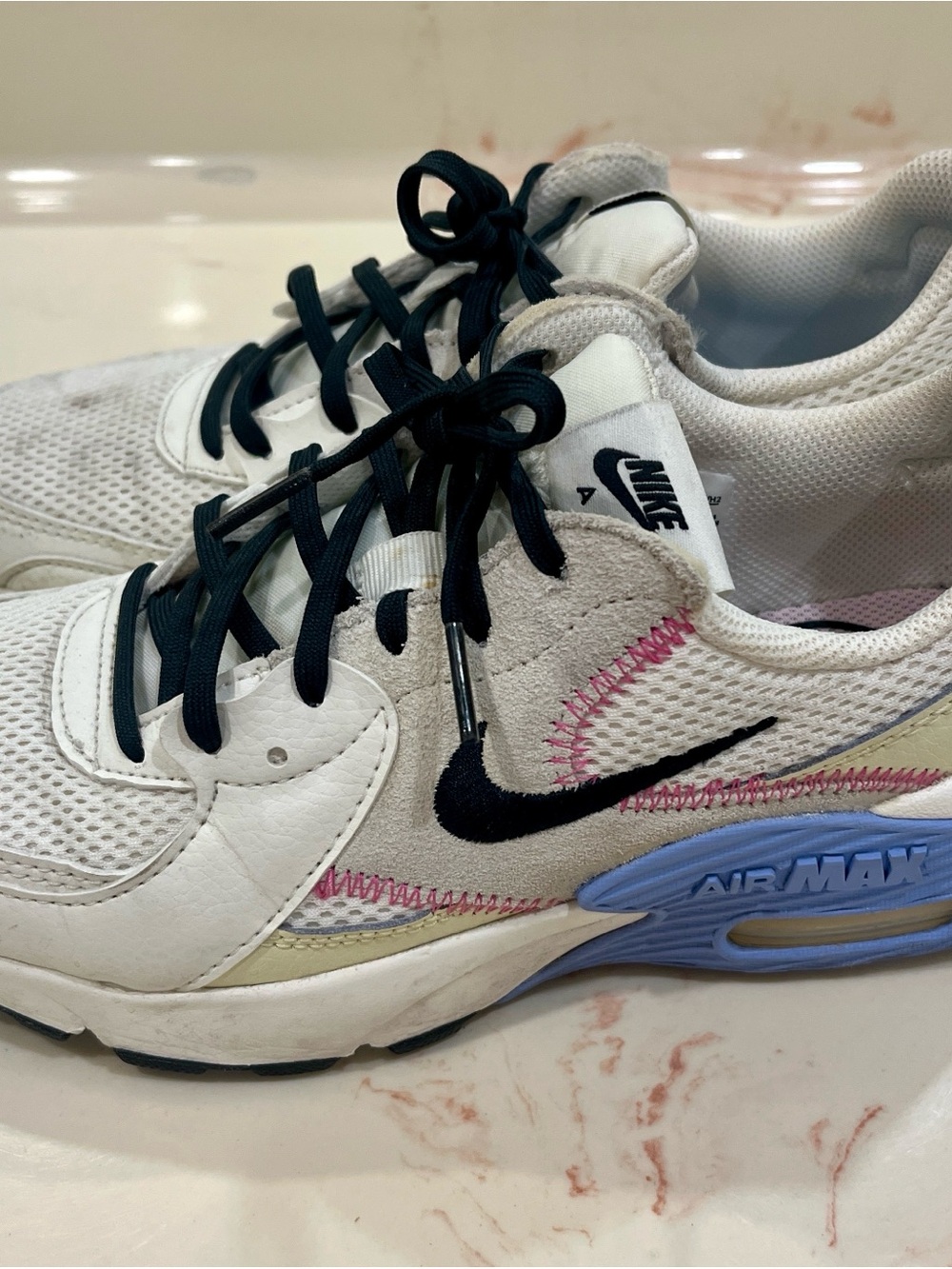 Nike White Sneakers with Black Swoosh and Light Blue Midsole